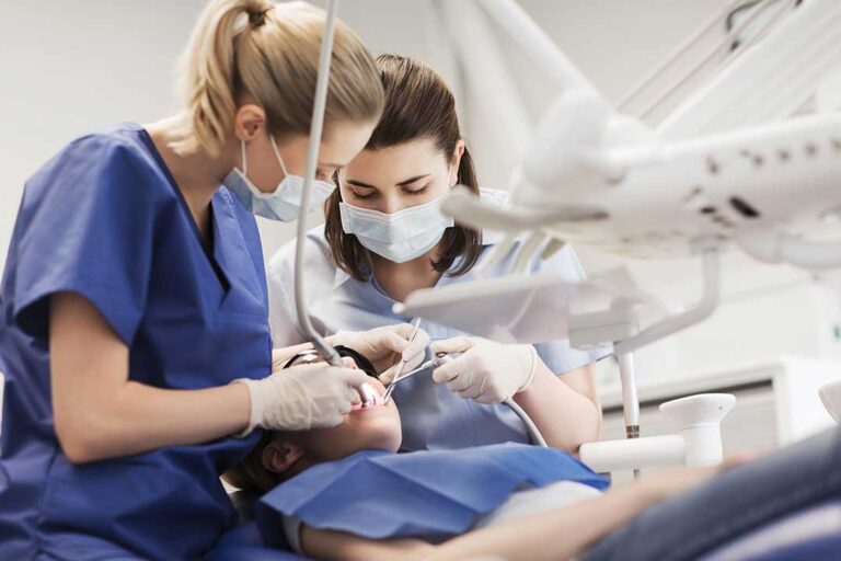 A person flossing their teeth in a bathroom using standard dental floss.